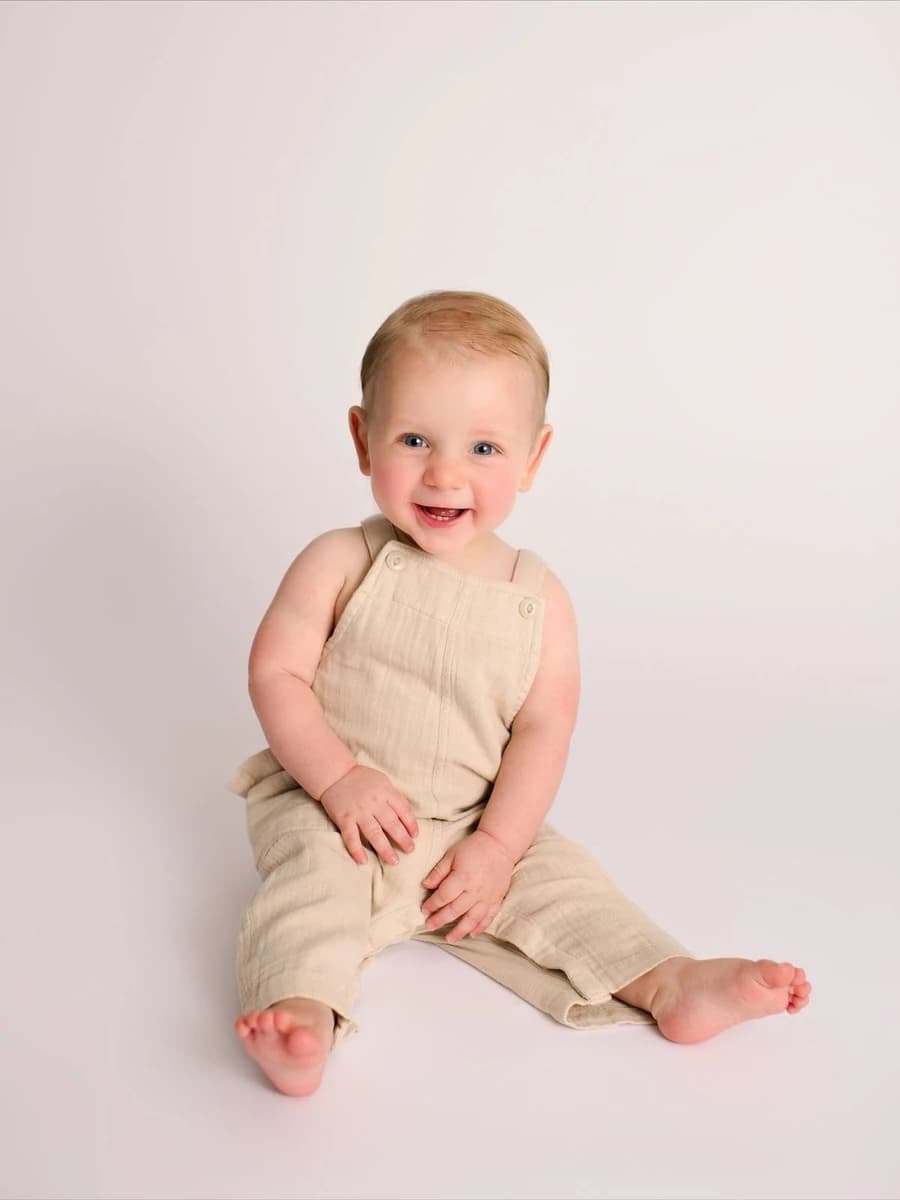 Front Shot - Full - Toddler sitting in a V shape by smiling at camera
