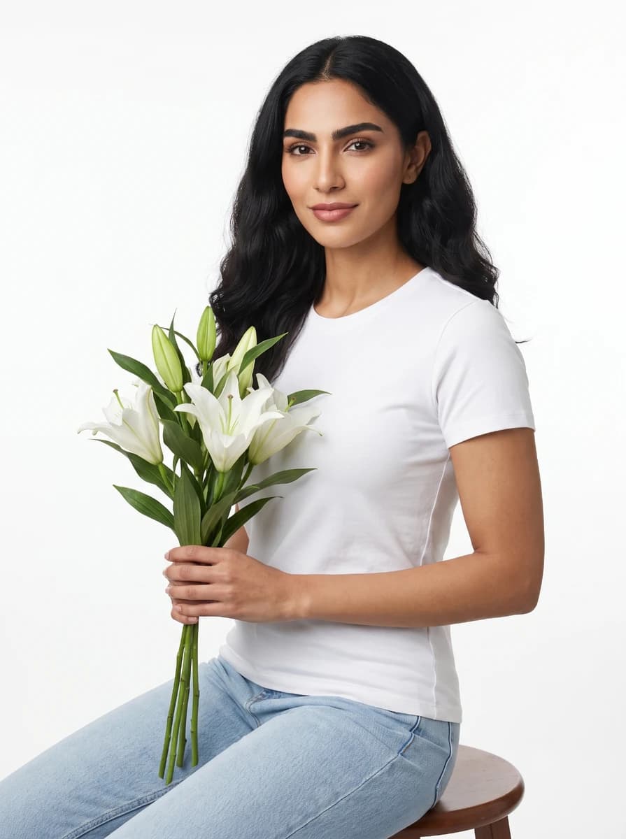Side shot - Full - Sitting while holding white flowers 