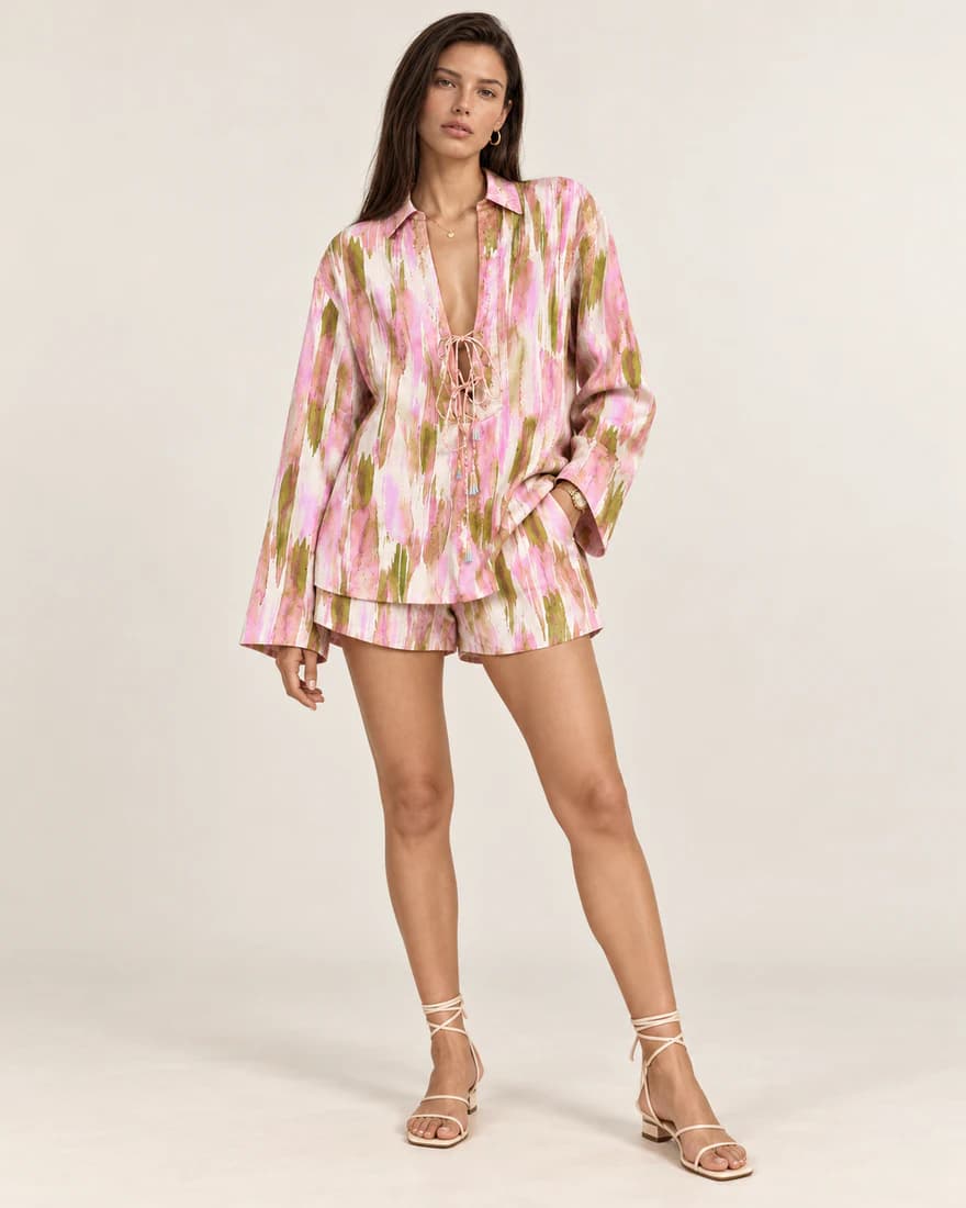 Model in a pink and olive brushstroke print shirt and matching shorts