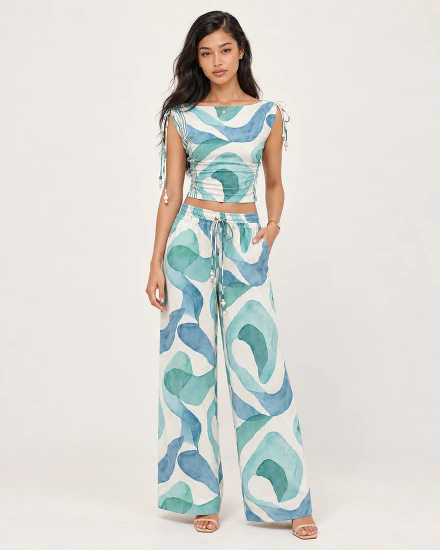 Model in a teal swirl print crop top and matching wide-leg trousers