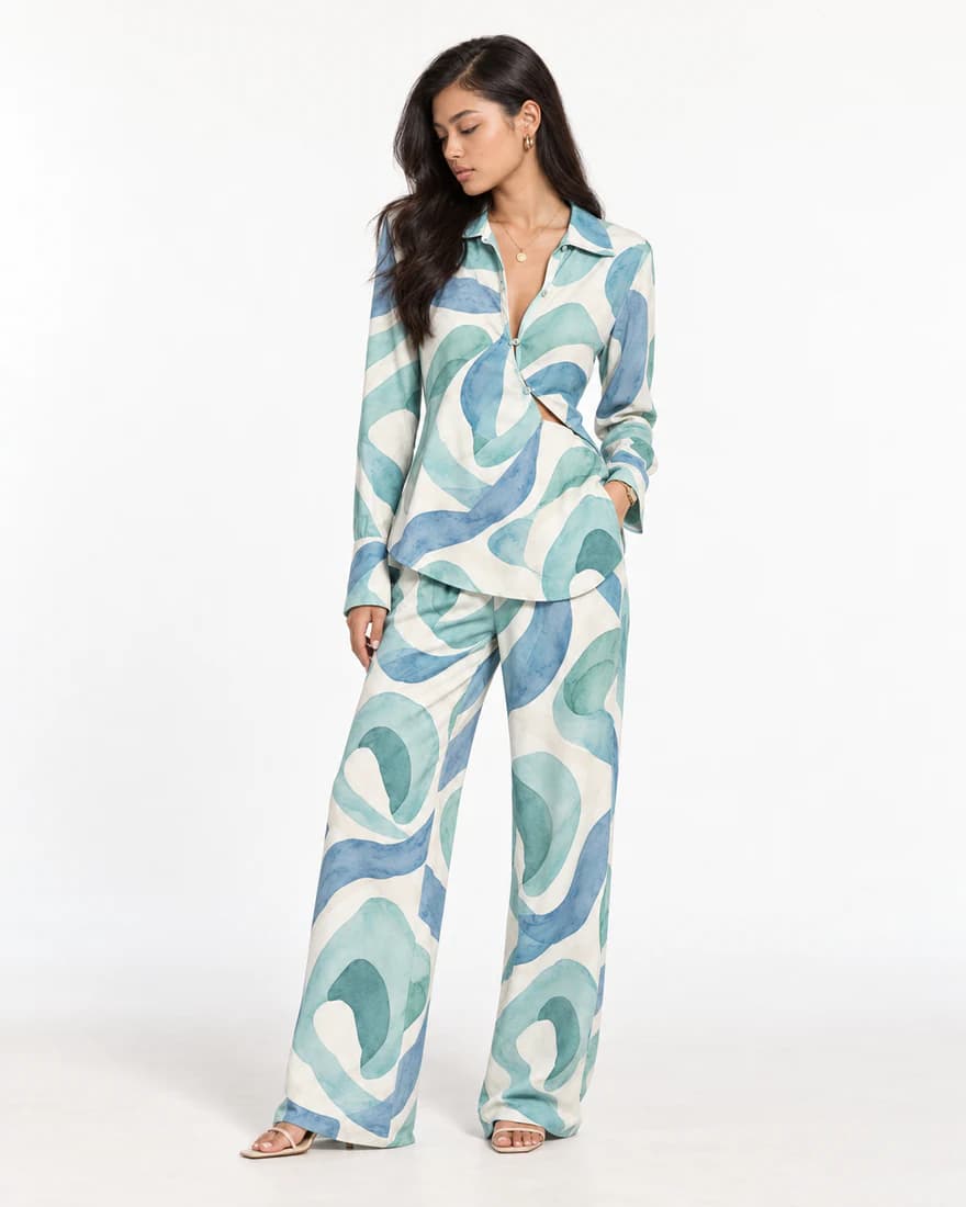 Model in a teal swirl print shirt and matching wide-leg trousers