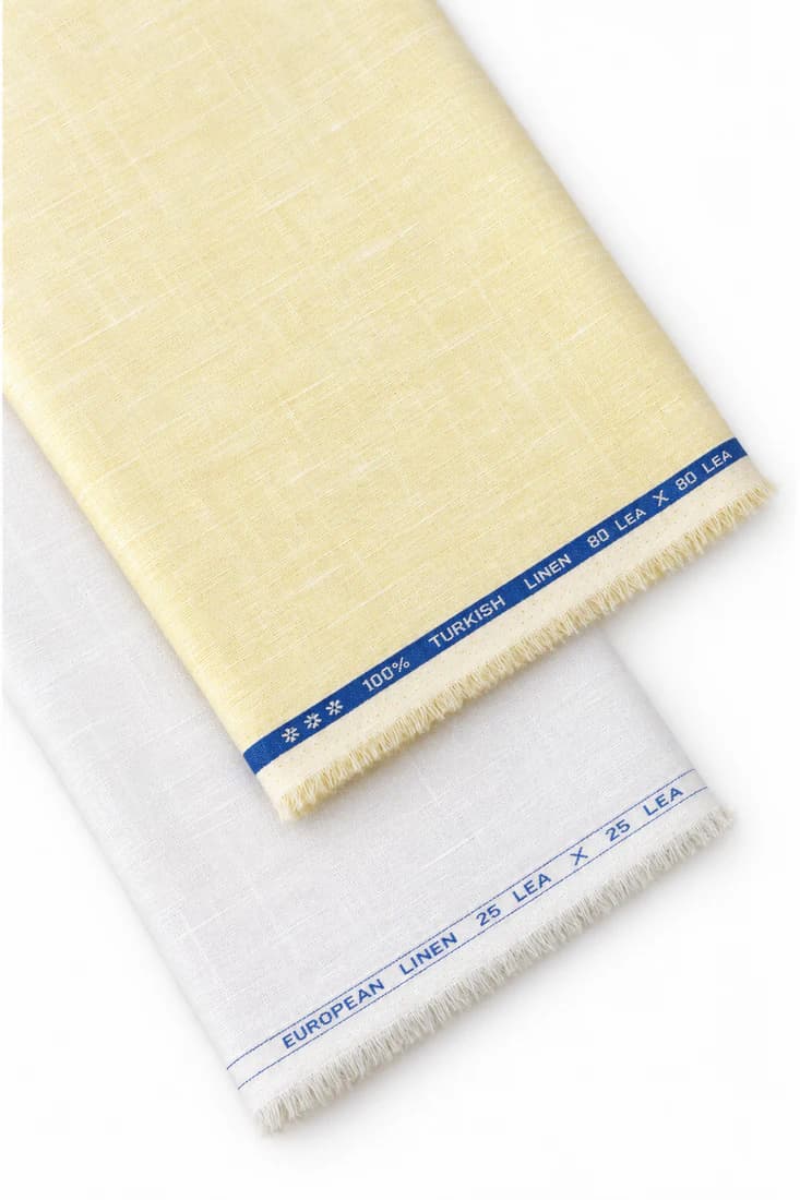 Folded lengths of yellow and white linen shirting fabric