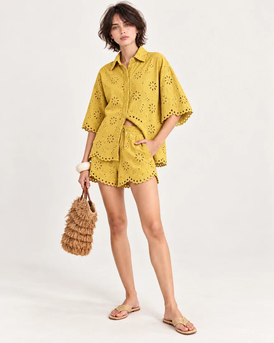 Model in a mustard eyelet shirt and matching scalloped shorts