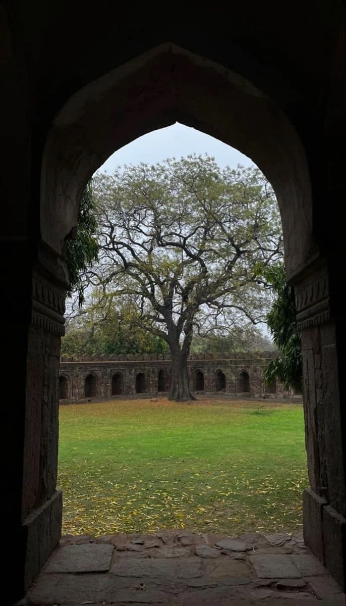 Dark interior of an ancient stone arched gateway.