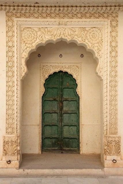 Scalloped arch with dark green doors