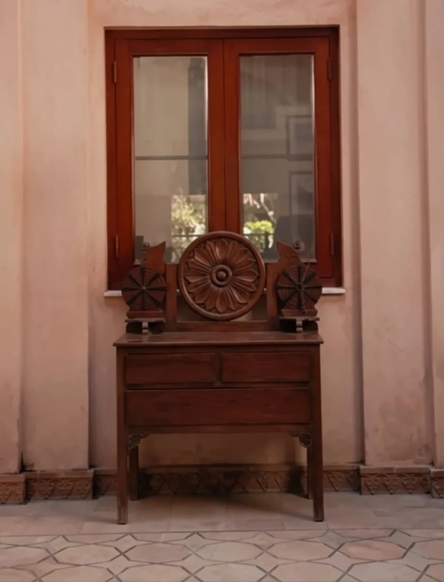 Neutral plaster background with antique furniture