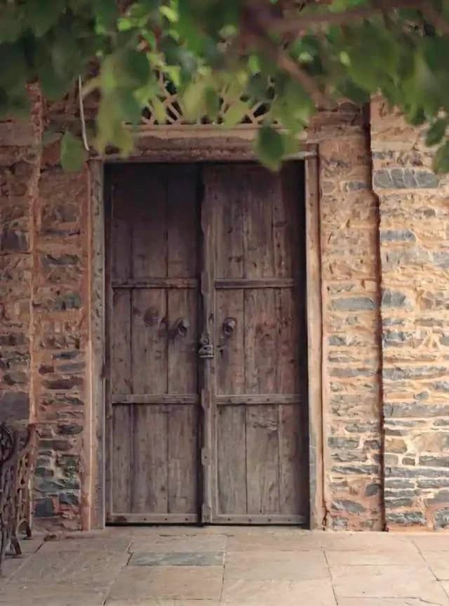 Rustic door with hanging green leaves